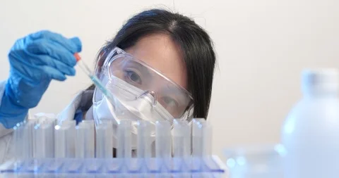 Female Scientist doing experiment with test tube in the lab Stock Footage 88748098
