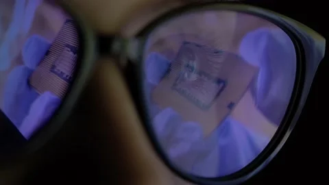 Female scientist in the glasses looking the presentation of the new microchip Stock Footage 163745686