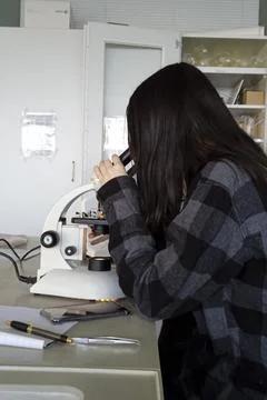 Female scientist in lab with microscope Stock Photos