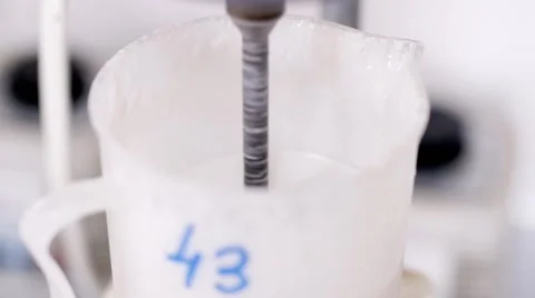 A female scientist loads vials of liquid into a centrifuge in a laboratory. Stock Footage 59759379