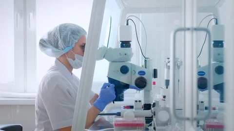 Female scientist looking microscope eyepiece. Portrait of woman scientist Stock Footage 126372735