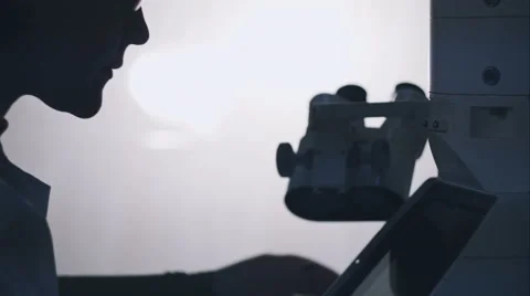 Female scientist looking through a microscope in laboratory Stock-Footage 58667402