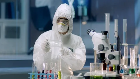 Female Scientist with a Microscope analyzes Genetic Code Stock Footage 119606405