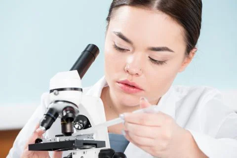 Female scientist with microscope Stock Photos