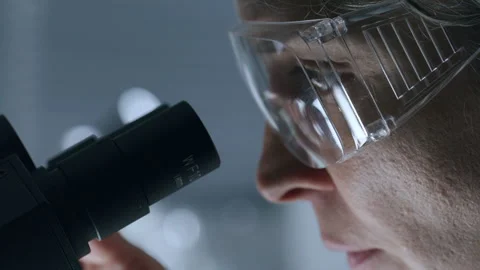 Female Scientist Observing Specimen through Microscope in Laboratory Stock Footage 291234588