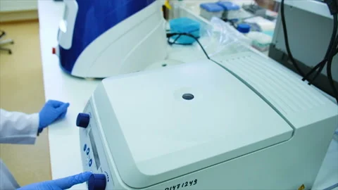 Female scientist pulls a substance from a refrigeration Stock Footage 103707800
