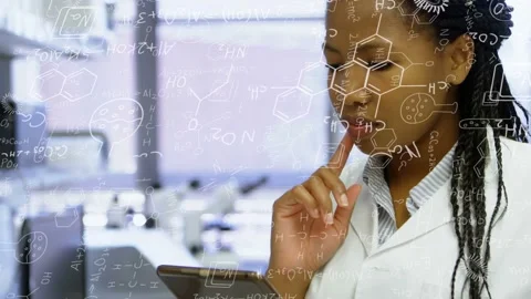 Female scientist reading tablet in lab tapping and touching lips while analyzing Stock Footage 335235029