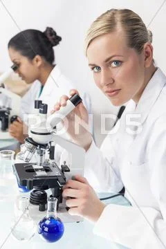 Female scientist research team using microscopes in laboratory Stock Photos