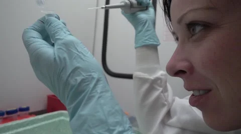 Female Scientist Smiles While Observing Sample Vial Stock Footage 62629847
