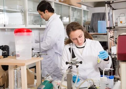 Female scientist taking notes in test chart Photos