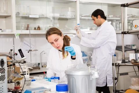 Female scientist taking notes in test chart Stock Photos