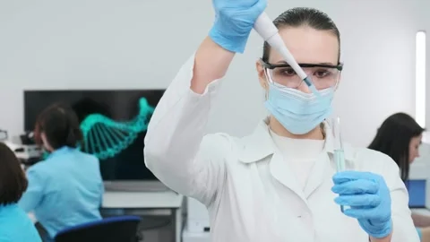 Female scientist using a micropipette for analysis in a modern laboratory. 動画素材 269280966