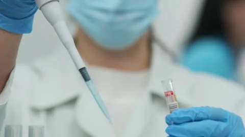 Female scientist using a micropipette for analysis in a modern laboratory. 動画素材 269283803