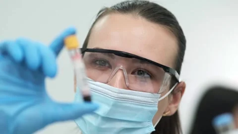 Female scientist using a micropipette for analysis in a modern laboratory. Видео 269284294