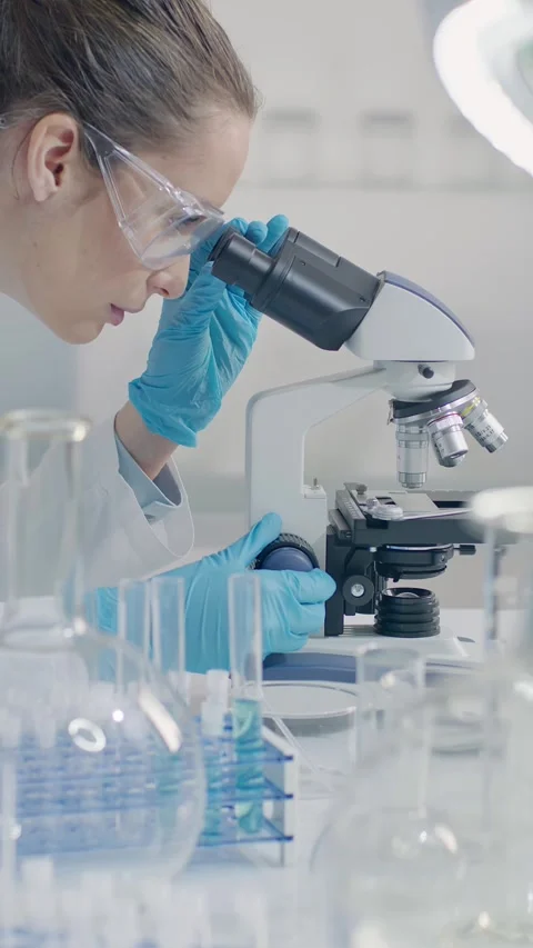 Female Scientist Using Microscope in Laboratory Stock Footage 327020013