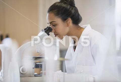 Female scientist using microscope in laboratory Stock Photos
