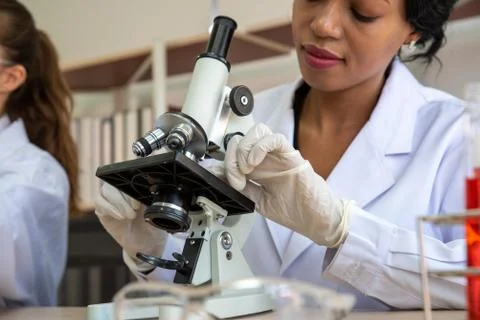 Female Scientist Using Microscope At Laboratory Stock Photos