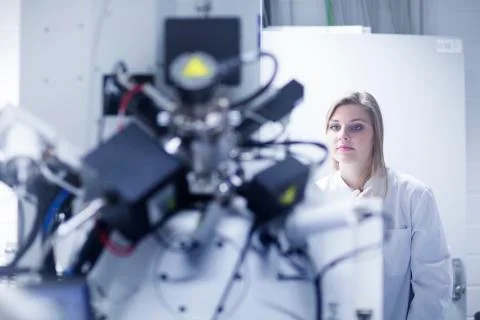 Female scientist using scanning electron microscope in lab Stock Photos