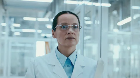 Female Scientist Walking through Corridor in Modern Laboratory Stockbeeldmateriaal 331336737