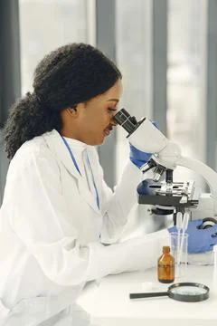 Female Scientist Working in The Laboratory Using a Microscope Stock Photos