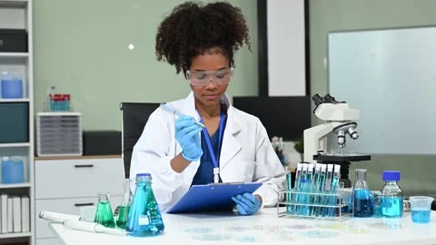 Female scientist working with micro pipettes analyzing biochemical samples,.. Stock Footage 313706065