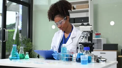 Female scientist working with micro pipettes analyzing biochemical samples,.. Stock Footage 313706074