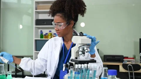 Female scientist working with micro pipettes analyzing biochemical samples,.. Stock Footage 313706084