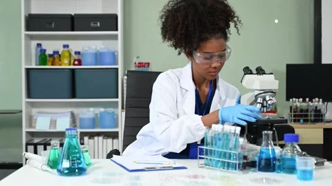 Female scientist working with micro pipettes analyzing biochemical samples,.. Stock Footage 313706090