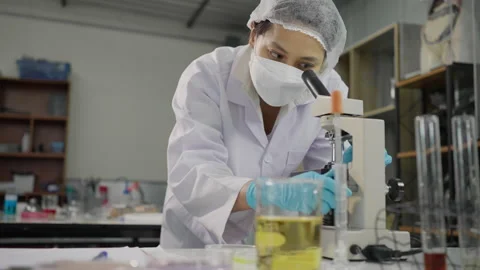 Female scientist working with microscope Stock Footage 201174113