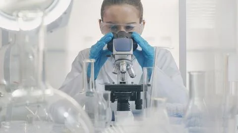 Female Scientist Working with Microscope Stock Photos
