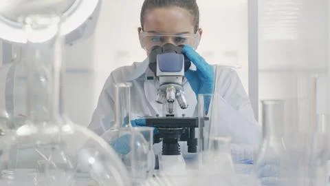 Female Scientist Working with Microscope Stock Photos