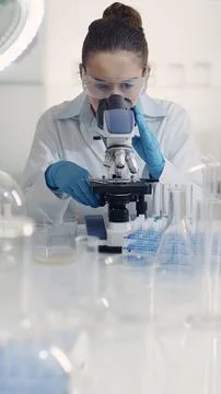 Female Scientist Working with Microscope Stock Photos