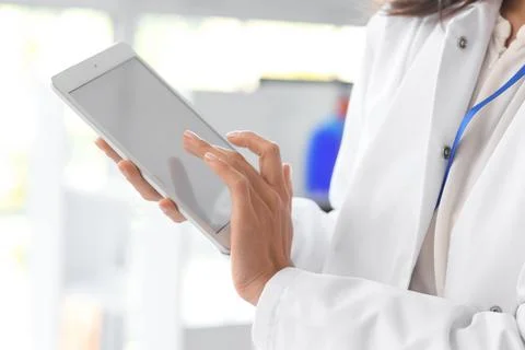 Female scientist working with tablet computer in laboratory, closeup Stock Photos