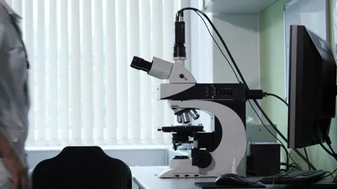A female scientist works with a microscope Stock Footage 92470475