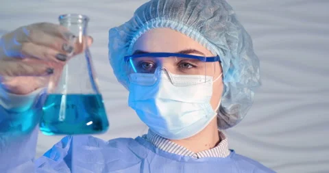 Female scientists developing new vaccine mixing  liquid in medical  test tube Stock Footage 152931423