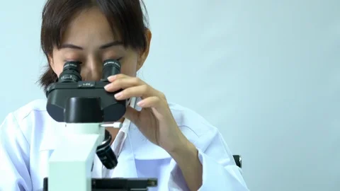 Female scientists looking through microscope. Stock Footage 106857243