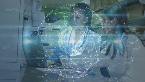 Female scientists positioning microscope and opening laptop starting globe Stock Footage 312771515