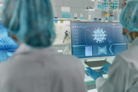 Female scientists working with microscope Biohazardous samples Stock Photos