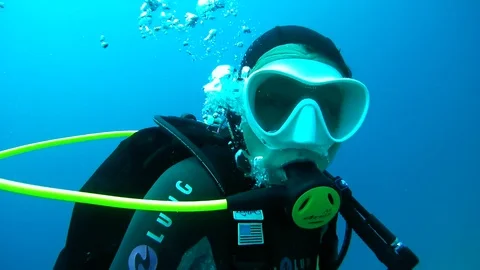 The female scuba diver swim in the blue water, Indian Ocean, Maldives Stock Footage