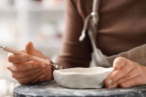 Female sculptor making pot in workshop, closeup Stock Photos