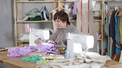 Female seamstress working on sewing machine in workshop Stock Footage 343710982