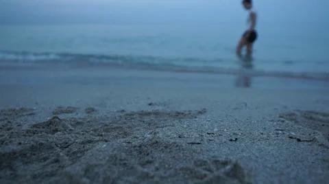 Female Searching for Shells after Sunset Stockbeeldmateriaal 39385040