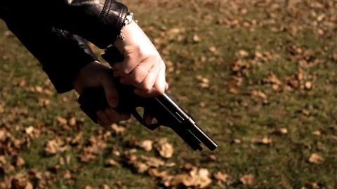 Female Secret Agent cocks pistol to object off camera   Action Movie Shots Stock Footage 72249774