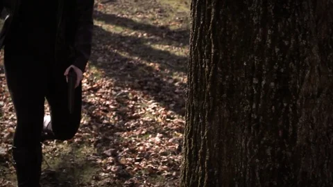 Female Secret Agent hides behind tree with gun V2   Action Movie Shots Stock Footage