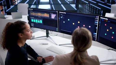 Female Security Experts Using Cybersecurity Monitor Dashboard Stock Footage 328398423