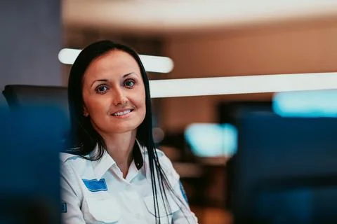 Female security operator working in a data system control room offices Technical Stock Photos