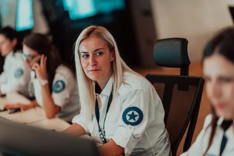 Female security operator working in a data system control room offices Technical Foto stock