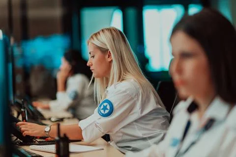 Female security operator working in a data system control room offices Tec... Foto stock