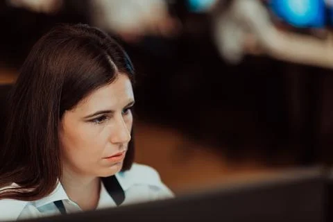 Female security operator working in a data system control room offices Technical Foto stock