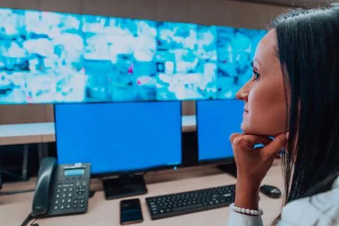 Female security operator working in a data system control room offices Technical Stock Photos